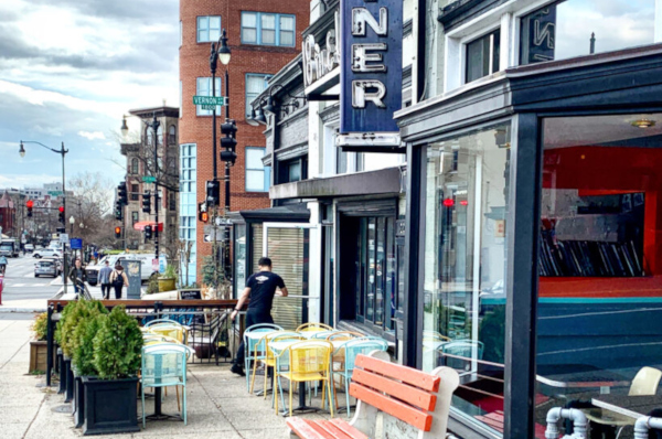 A vibrant sidewalk adorned with benches and tables